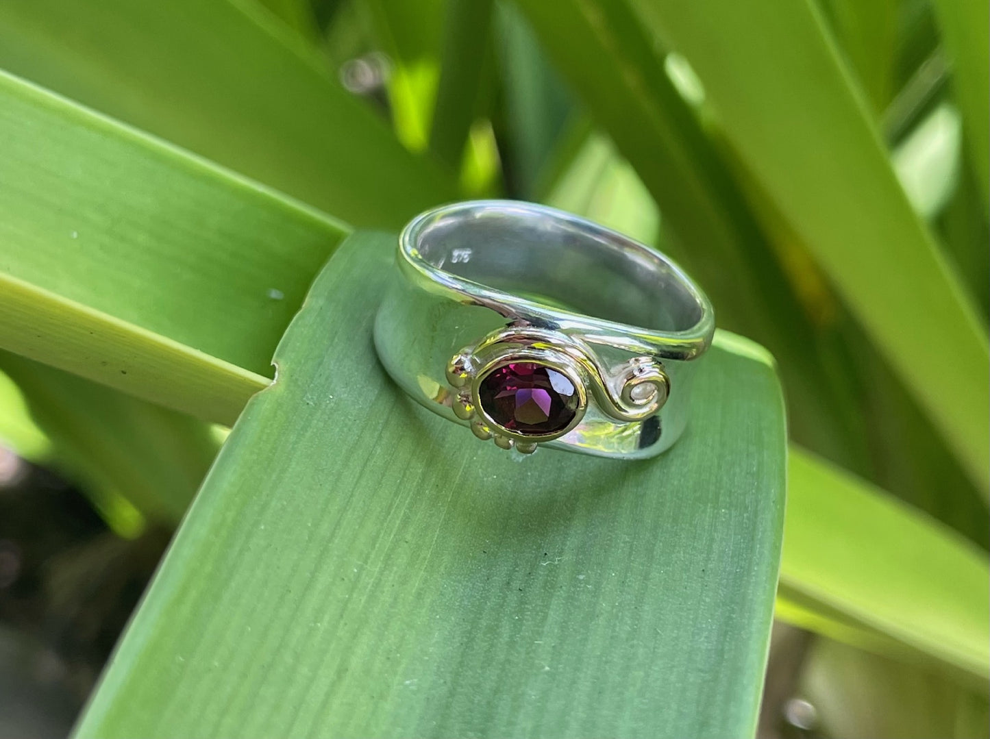 Sterling Silver Bezel Set Garnet Ring with Rose Gold Swirl